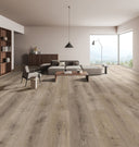 Grey woodgrain laminate plank flooring in a spacious living room floor view