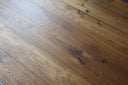 Smoked brushed oiled engineered wood flooring planks showing knots and long plank boards
