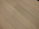 Engineered hardwood flooring close-up, light wood planks with linear grain