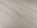 Light gray wood flooring planks with straight seams and small knots
