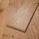 Engineered wood plank stack showing straight edges and light brown grain