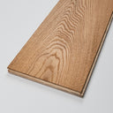 Light brown wooden flooring plank with pronounced swirling grain pattern