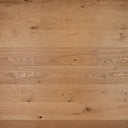 Light brown engineered wood flooring boards laid in a staggered pattern