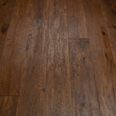 Engineered antique brown distressed wood flooring with plank seams and natural grain.