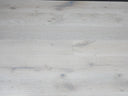 Whitewashed engineered wood plank flooring with staggered seams and pale grain