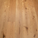 Rustic engineered wood flooring with warm natural boards, knots, and visible wood grain