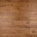 Wood floor boards in warm golden brown with straight plank layout and natural knots