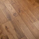 Hardwood flooring close-up with varied grain patterns and warm oiled golden brown color