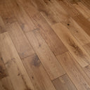 Brushed oiled wood flooring, light-to-warm brown planks with varied grain and knots
