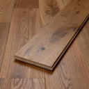 Brushed oiled wood flooring plank edge with visible joint line and thickness