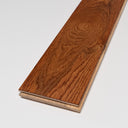 Handscraped solid wood flooring plank in warm golden brown with beveled edge
