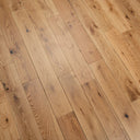 Lacquered light wood plank flooring with knots, visible grain, and straight seams