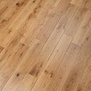 Lacquered light wood plank flooring showing knotty grain and tight plank seams