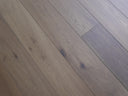 Engineered wood flooring planks in cool grey tones with natural knots and wood grain