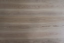 Light neutral engineered wood flooring close-up with swirling woodgrain pattern