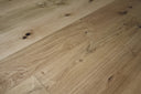 Light natural oak engineered wood flooring boards with visible grain and small knots.