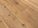Natural oak-toned engineered wood flooring planks with visible knots and grain