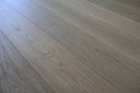 Engineered wood flooring planks, light gray with diagonal wood-grain pattern