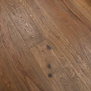 Distressed light brown engineered wood flooring planks with visible grain and knots