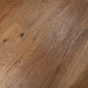 Light brown distressed engineered wood flooring planks with dark speckling and grain