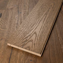 Engineered wood flooring plank, distressed light brown, with beveled end profile