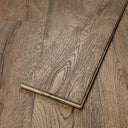 Distressed dark brown engineered wood flooring plank with beveled edge, close-up seam