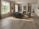 Light oak engineered wood flooring with plank seams and knots, wide plank look