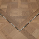 Natural SPC flooring panel with herringbone parquet pattern and beveled edges