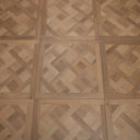 Natural wood-look SPC flooring panel with interlocking herringbone parquet pattern