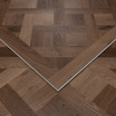 Caramel brown parquet wood floor panel with chevron borders forming a V shape