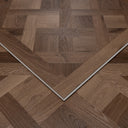 Caramel brown parquet SPC floor panel with chevron wood pattern and white beveled edge