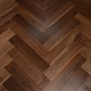 Engineered walnut herringbone wood flooring with dark lacquered planks
