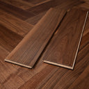 Engineered walnut herringbone flooring planks with visible click-lock edges