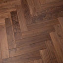 Walnut engineered wood herringbone flooring, wide plank pattern close-up