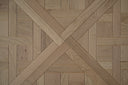 Light oak parquet wood panel close-up with cross herringbone wood grain texture