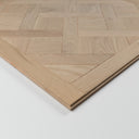 Light wood unfinished parquet panel with visible layered edge profile on corner