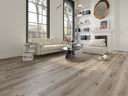 Light gray wood-look laminate flooring with wide plank boards