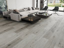 SPC vinyl flooring in light gray woodgrain, wide plank installation view
