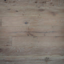 Distressed light wood plank flooring with knots and blue-gray wear marks