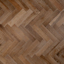 Engineered herringbone wood flooring in smoked light-brown with visible grain