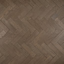 Engineered herringbone wood flooring in gunmetal grey, brushed matte finish close-up