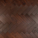 Walnut brown engineered herringbone wood floor planks with brushed grain texture