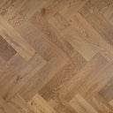 Smoked engineered herringbone wood flooring with warm brown plank pattern