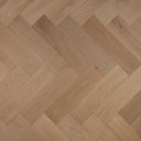 Engineered herringbone wood flooring, light oak tone, diagonal plank pattern close-up