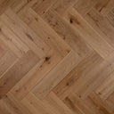 Engineered herringbone wood flooring, brushed natural oak color with visible knots