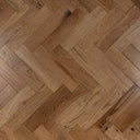 Engineered herringbone wood flooring, warm light-brown oak planks close-up