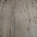Antique distressed engineered wood planks in light beige, visible knots and scratches