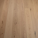 Beige wood plank flooring with knotty texture and matte surface