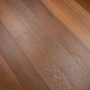Smoked oak SPC flooring detail with brushed texture and long plank lines