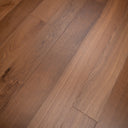 Smoked oak SPC flooring close-up with variegated woodgrain across planks